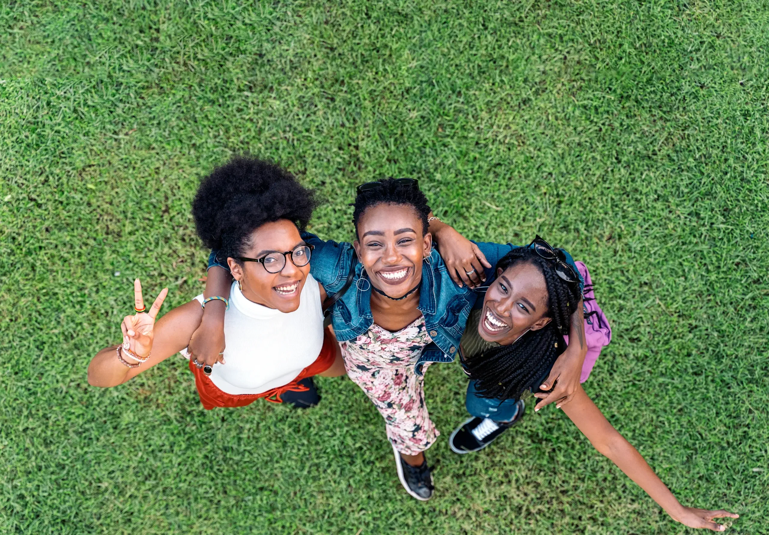 Friends smile and pose for the camera in a courtyard